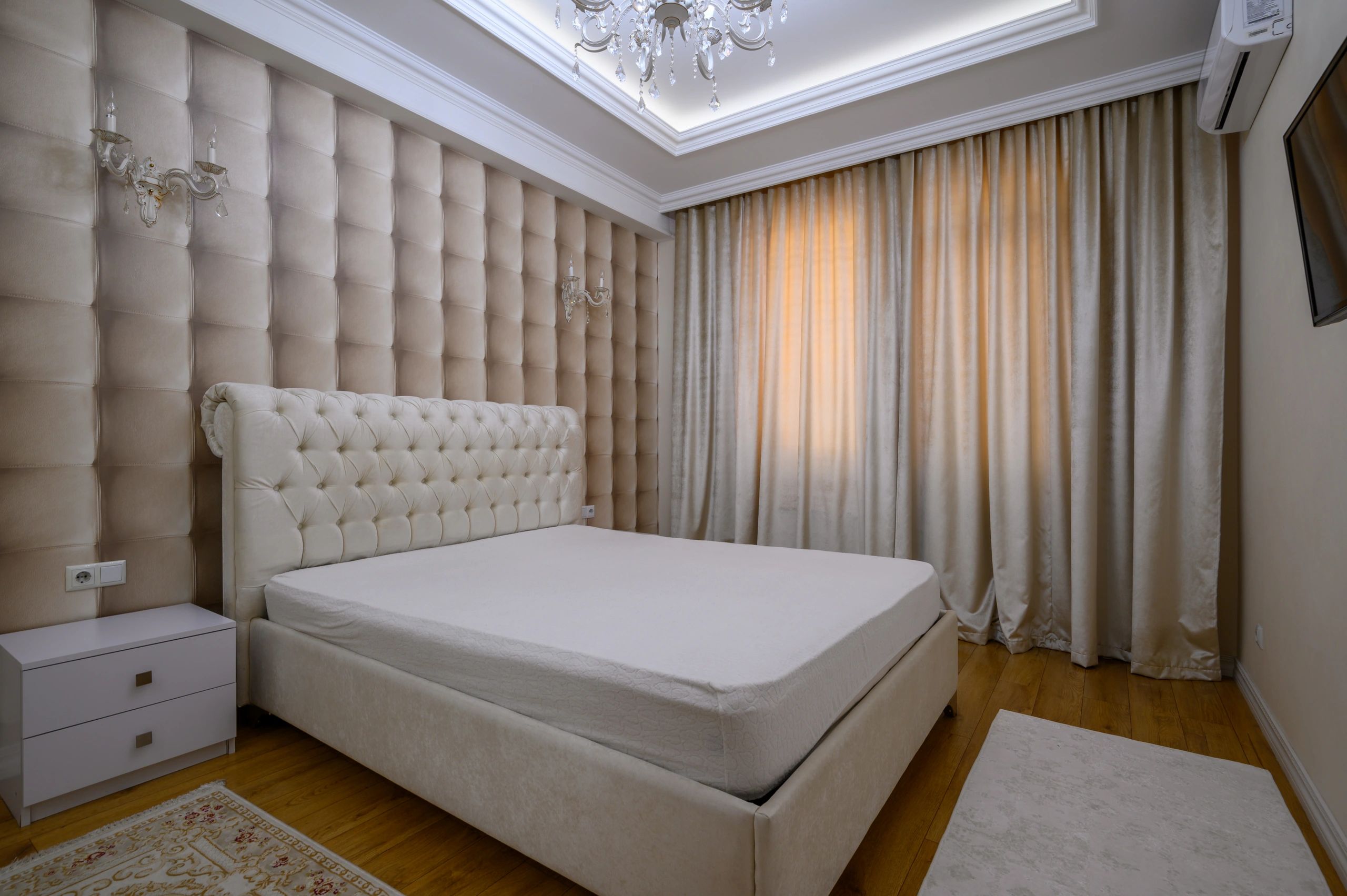 Modern bedroom showcasing a neatly made bed and bedside tables