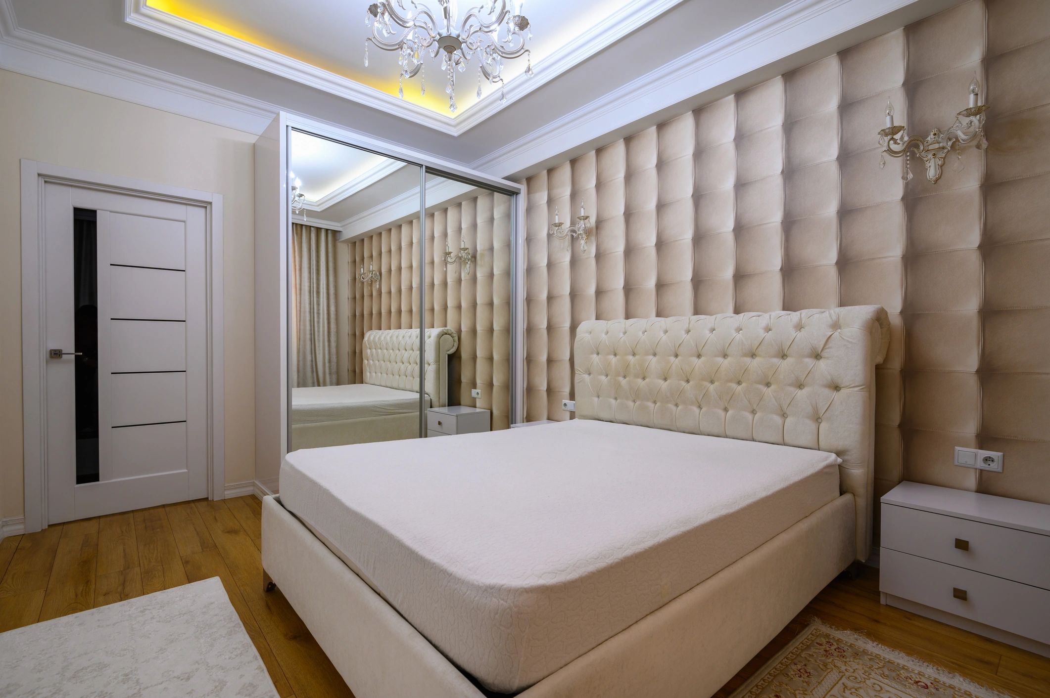 Elegant bedroom interior featuring a wooden bed frame and neutral decor