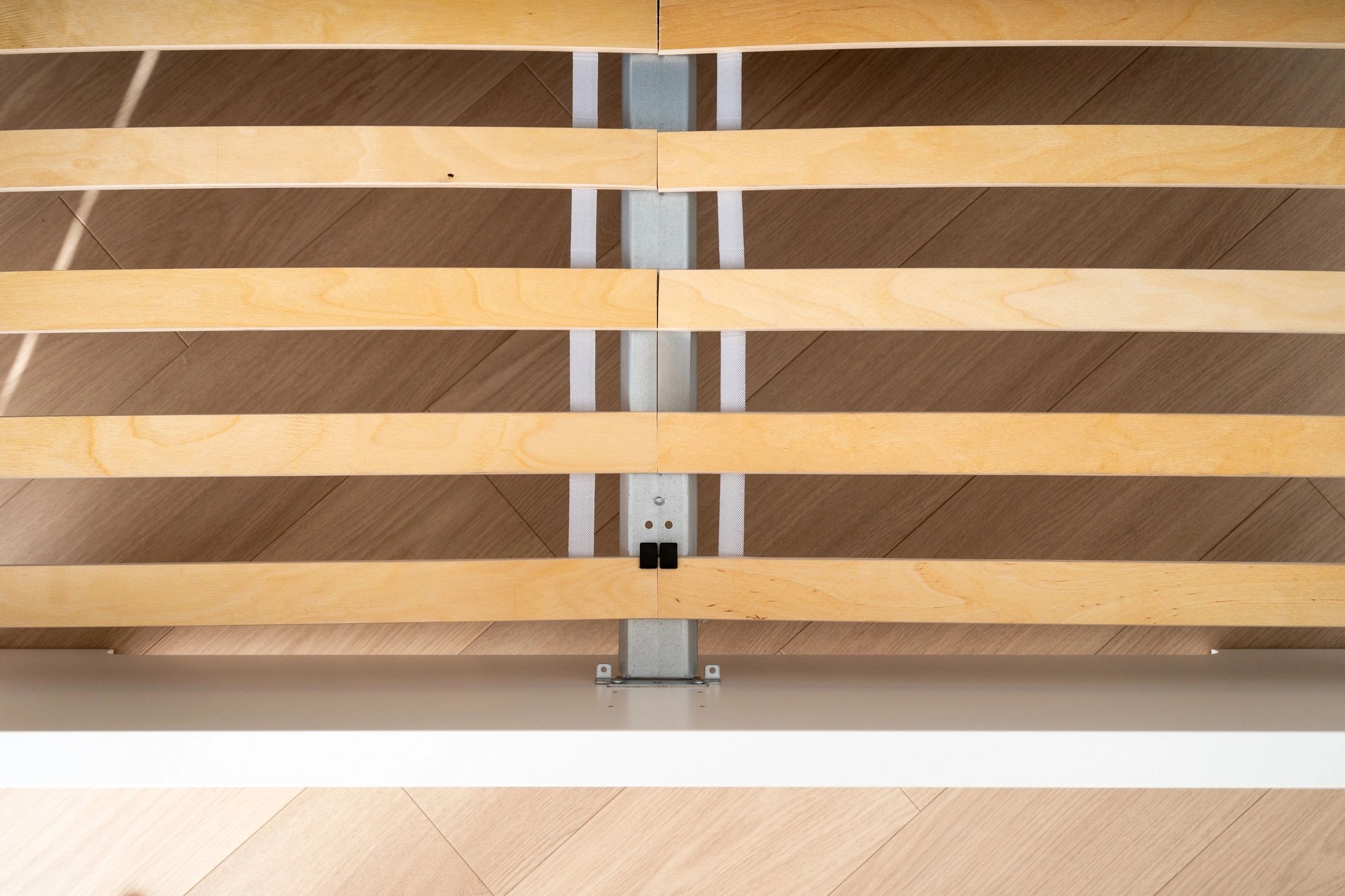 Close-up of a modern bed frame showing slats and clean construction details