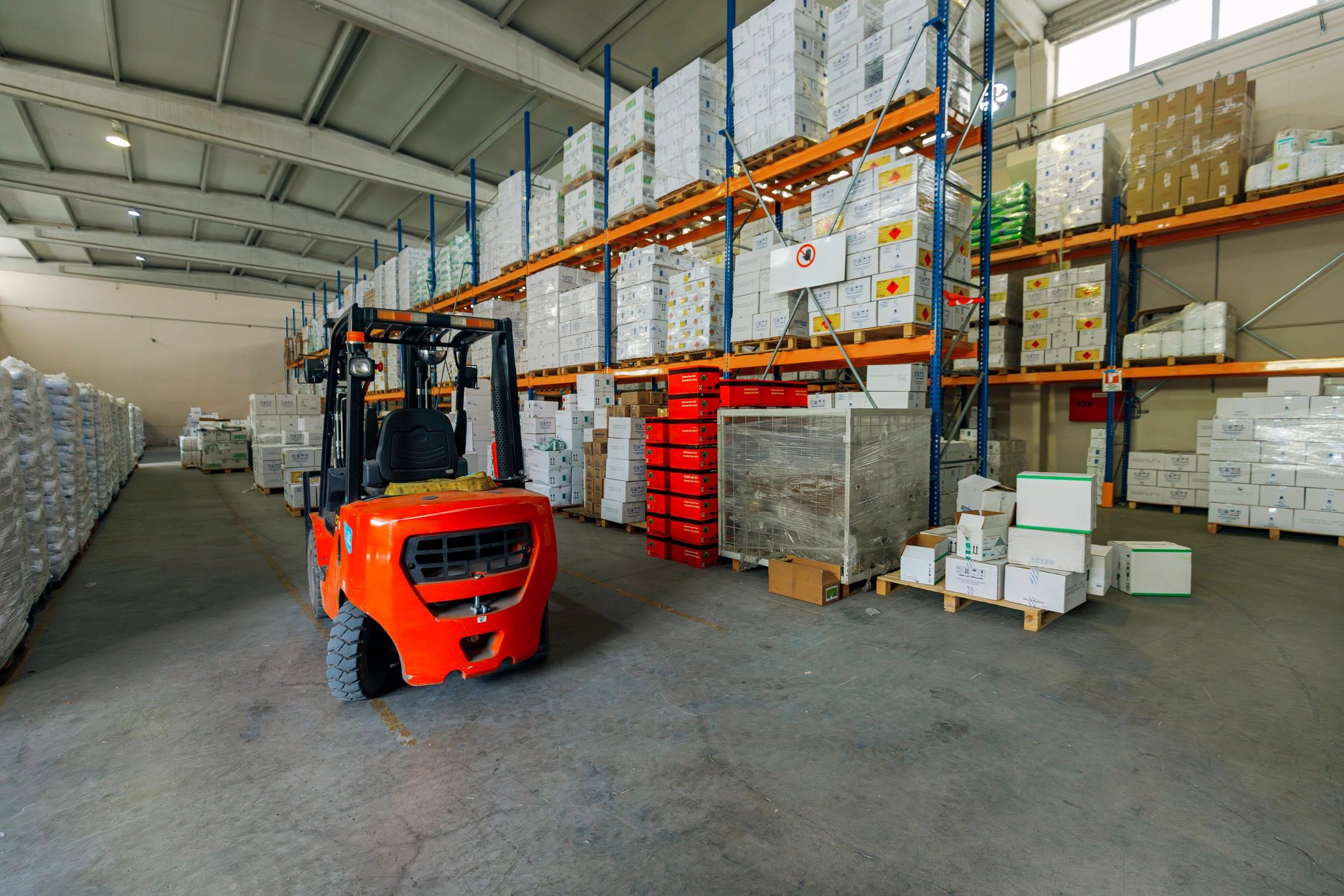 Warehouse aisle with palletized goods, representing bulk order logistics