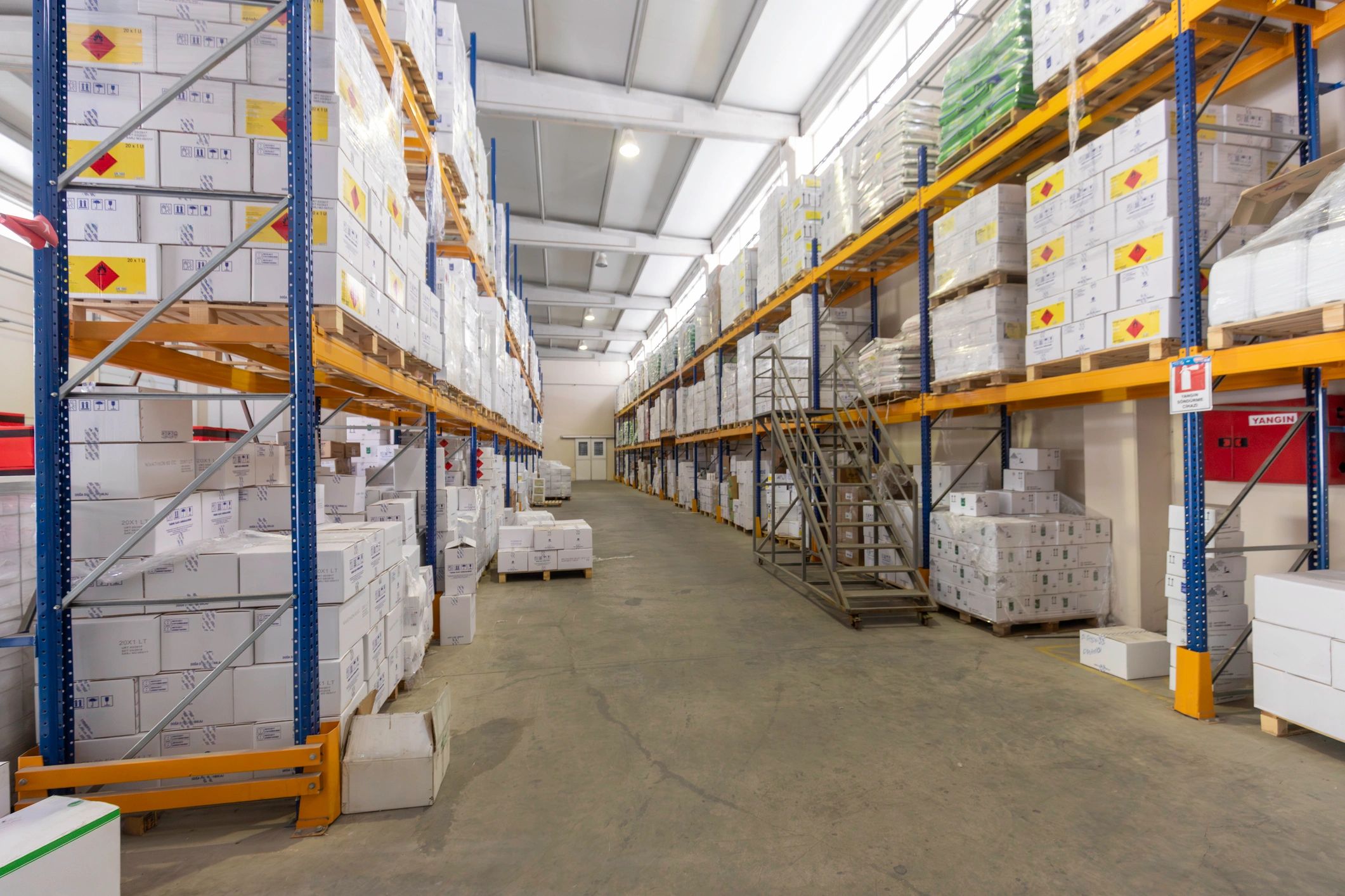 Organized warehouse shelves, representing bulk distribution and retailer supply