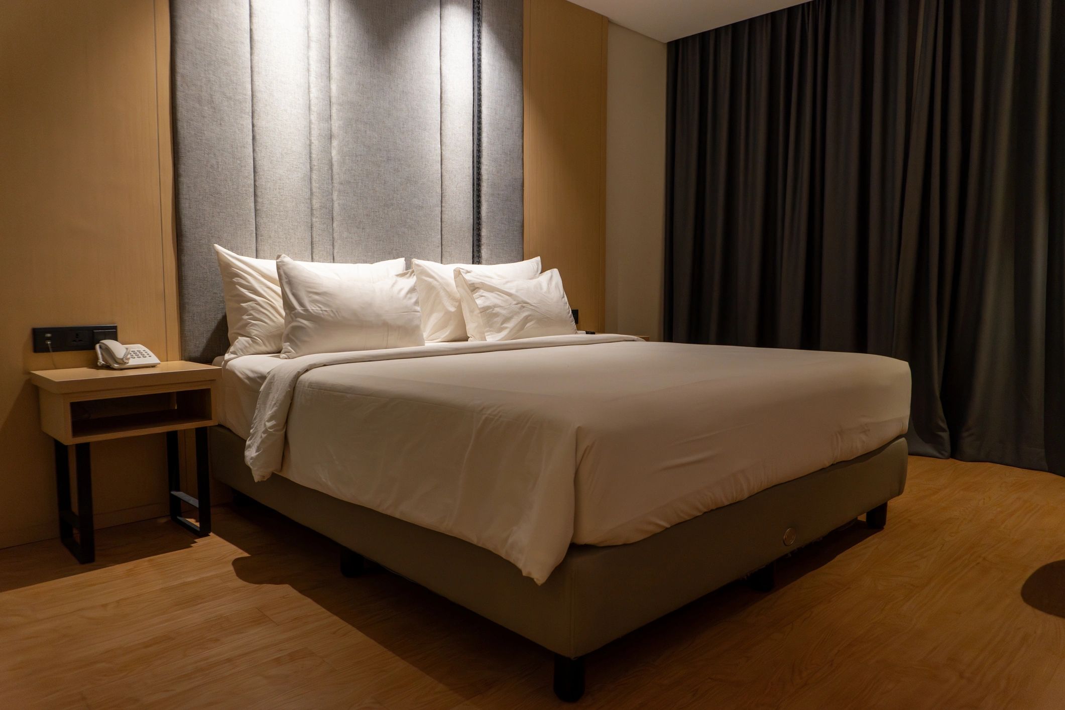 Neatly made bed in a hotel room
